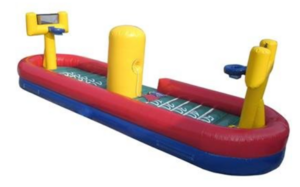 Inflatable tug and dunk game set up at an outdoor Phoenix event with two adult players competing.